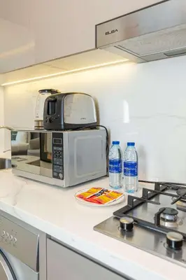 a microwave sitting on top of a kitchen counter at PVH - Modern Studio Near Downtown - Azizi Riviera in Dubai
