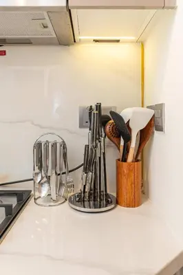a kitchen counter with utensils on a counter top at PVH - Modern Studio Near Downtown - Azizi Riviera in Dubai