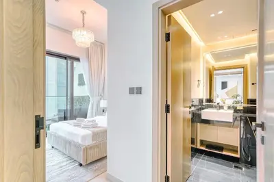 a bathroom with a bed and a sink and a mirror at PVH - Exquisite 1BR With Canal View - Binghatti Canal, Business Bay in Dubai