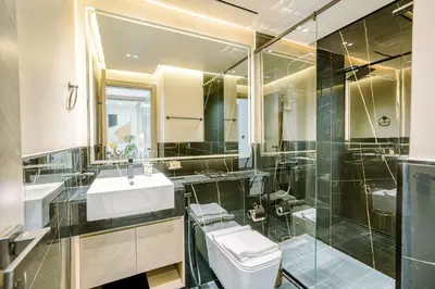 a bathroom with a toilet and a sink and a shower at PVH - Exquisite 1BR With Canal View - Binghatti Canal, Business Bay in Dubai