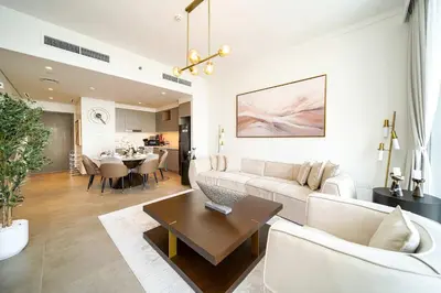 a living room with a couch and a table at PVH - Creek Gate - Stylish 2BR with Creek View in Dubai