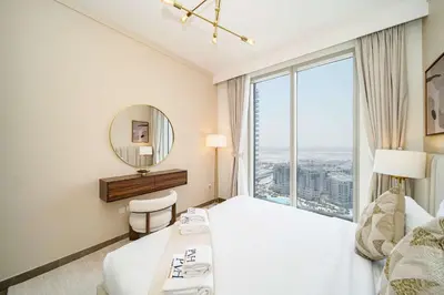 a hotel room with a bed and a mirror at PVH - Creek Gate - Stylish 2BR with Creek View in Dubai