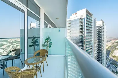 a balcony with chairs and tables in a building at PVH - Classy Studio with Golf Course View - Carson in Dubai