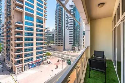 a balcony with a view of a city with tall buildings at PVH - 2BR near Marina Promenade - Marina Pearl in Dubai