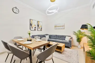 a living room with a table and a couch at PVH - 2BR near Marina Promenade - Marina Pearl in Dubai