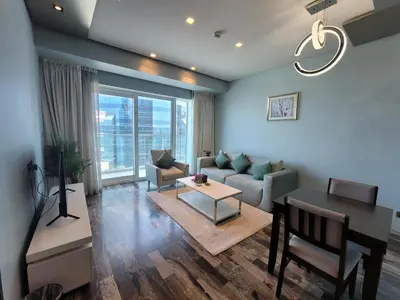 a living room with a couch and a table at Damac Heights - Blue Ocean Holiday Homes in Dubai