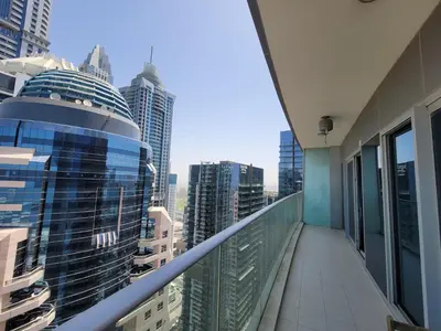 an apartment balcony with a view of a city at Damac Heights - Blue Ocean Holiday Homes in Dubai