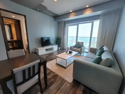 a living room with a couch and a table at Damac Heights - Blue Ocean Holiday Homes in Dubai