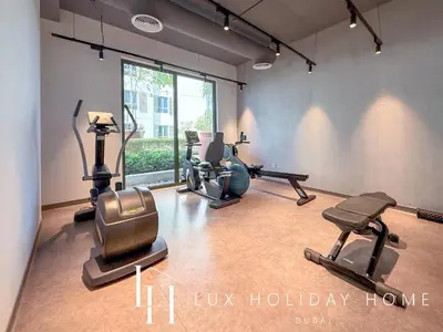 a gym with several exercise equipment in a room at LUX The Le Pont Sea View Suite in Dubai