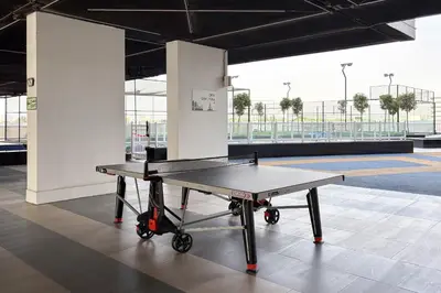 a ping pong table in a large room with at Luxury 3Br Apts with Private Pool in Gemz by Simply Comfort in Dubai