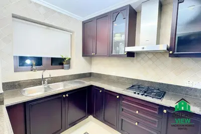 a kitchen with purple cabinets and a sink at Souk Al Bahar connected to Dubai Mall, Burj khalifa Partial View Dream View Holiday Home Rental in Dubai