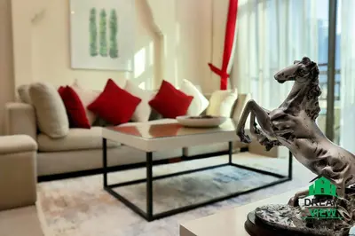 a living room with a statue of a dog on a table at Souk Al Bahar connected to Dubai Mall, Burj khalifa Partial View Dream View Holiday Home Rental in Dubai