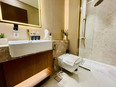 a bathroom with a toilet and a sink and a shower at Business Bay Studio Jacuzzi & Iconic View in Dubai