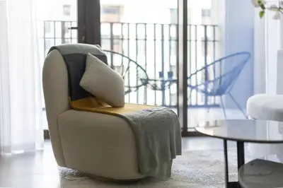 a living room with a chair and a table at Maison Privee - Serene Hideaway with Top Facilities in Creek Beach in Dubai