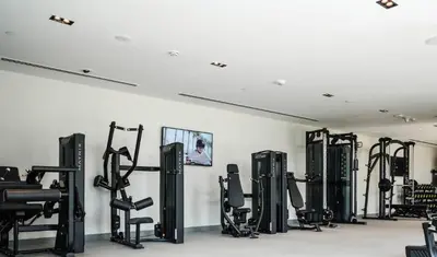 a gym with rows of exercise bikes and treadmills at Modern 2BR at Burj Crown Walk to Burj Khalifa by Vibel Stay in Dubai