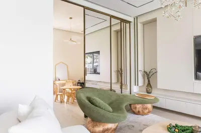a living room with a green couch and a table at Luxury Villa with Pool and Garden 4BR The Springs in Dubai