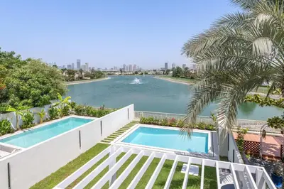 a view of the water from the balcony of a house at Luxury Villa with Pool and Garden 4BR The Springs in Dubai