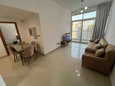 a living room with a couch and a table at Wonderful Rental Apartments in Dubai Silicon Oasis in Dubai