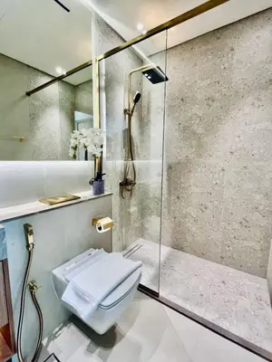 a bathroom with a shower and a toilet at Cozy 1br In Jvc Pool, Balcony & Free Parking in Dubai