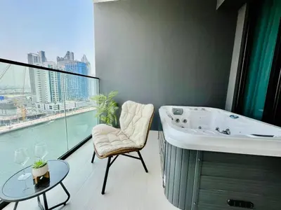 a bathroom with a bath tub and a table and a window at Canal-view Studio Jacuzzi Business Bay in Dubai