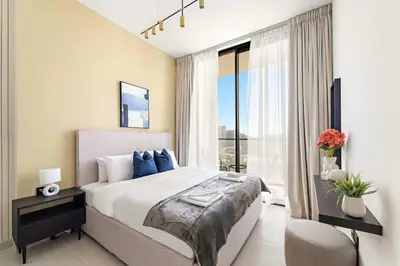 a bedroom with a large bed and a large window at Silkhaus New 1BDR Retreat at Binghatti Tulip in JVC in Dubai