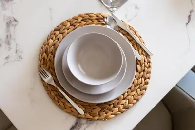 a table set with a plate and a glass at GuestReady - Premium stay in JBR walk in Dubai