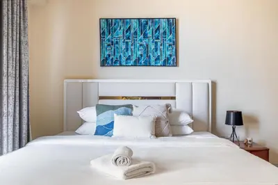 a bedroom with a white bed with towels on it at GuestReady - Premium stay in JBR walk in Dubai