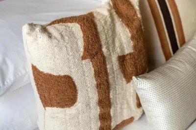 a brown and white pillow sitting on a bed at GuestReady - Premium stay in JBR walk in Dubai