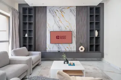 a living room with a couch and a table at GuestReady - Premium stay in JBR walk in Dubai
