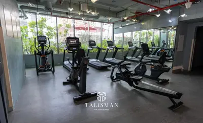 a gym with treadmills and ellipticals in a room at Canal View Studio MAG 318 in Dubai