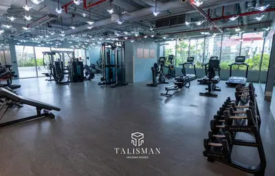 a gym with treadmills and machines in a room at Canal View Studio MAG 318 in Dubai