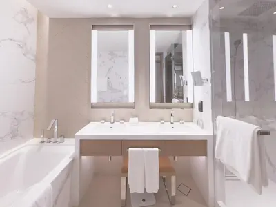 a white bathroom with a sink and a tub and a mirror at ADDRESS Residences Opera 2BR Tower 1 - EPIC 30th floor Burj Khalifa view byBLCK with DXB AIRPORT VIP Shuttle option in Dubai