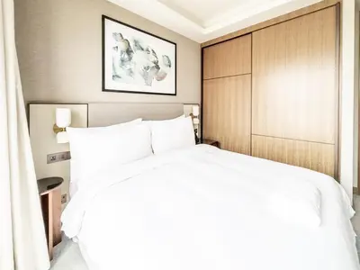 a bedroom with a large white bed in a room at ADDRESS Residences Opera 2BR Tower 1 - EPIC 30th floor Burj Khalifa view byBLCK with DXB AIRPORT VIP Shuttle option in Dubai