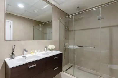 a bathroom with a sink and a glass shower at 3BR Apartment in the heart of Dubai Marina in Dubai