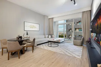 a living room with a couch and a table at Modern 1BR in Avanti with Pool & Gym in Dubai