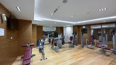 a gym with several treadmills and cardio machines at Modern 1BR in Avanti with Pool & Gym in Dubai