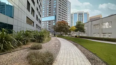 a walkway in the middle of a city with tall buildings at Modern 1BR in Avanti with Pool & Gym in Dubai