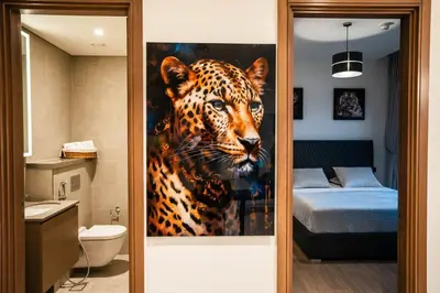 a bathroom with a painting of a leopard at Sobha Waves Grande Big 1BR apt Burj Khalifa views! in Dubai