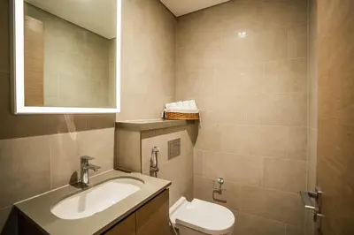 a bathroom with a sink and a toilet at Sobha Waves Grande Big 1BR apt Burj Khalifa views! in Dubai