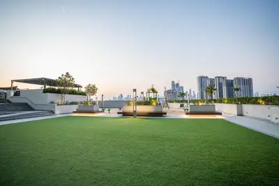 a green lawn on the roof of a building at Sobha Waves Grande Big 1BR apt Burj Khalifa views! in Dubai