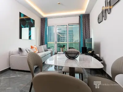 a living room with a table and a couch at Cozy and Uniquely Furnished One Bedroom Dubai Marina in Dubai