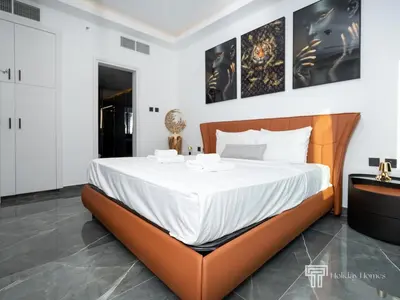 a bedroom with a large bed with white sheets at Cozy and Uniquely Furnished One Bedroom Dubai Marina in Dubai