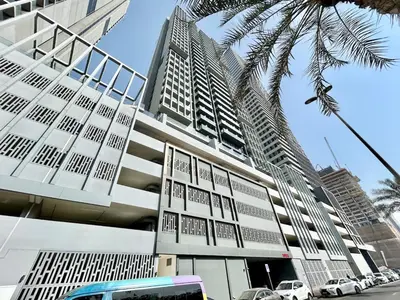a tall building with cars parked in front of it at Homes2Retreat - Luxury Finishes with Full Skyline View in Dubai