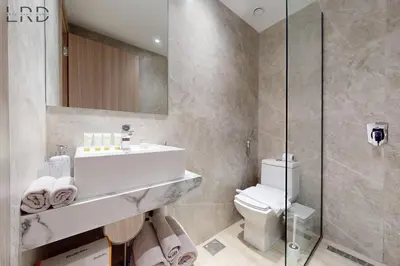 a bathroom with a sink and a toilet at Brand New and Modern Studio Apartment in Dubai