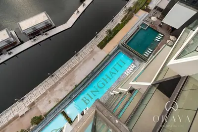an overhead view of a building with a swimming pool at Studio With Jaw-Dropping Canal And Burj Views in Dubai