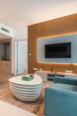a living room with a couch and a table at Bright & Elegant Saven The Palm 1bhk Apartment in Dubai