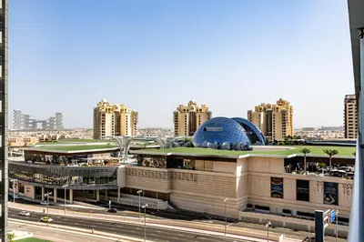 a large building with a blue dome on top of it at Bright & Elegant Saven The Palm 1bhk Apartment in Dubai