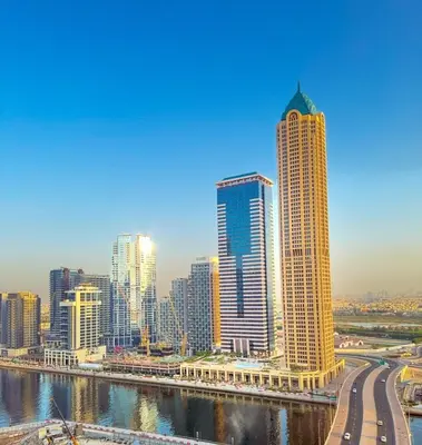 a city with tall buildings next to a river at CasaHue - Canal x Burj View - 4Guest - Award Winning in Dubai