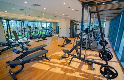 a gym with a bunch of treadms and machines at CasaHue - Canal x Burj View - 4Guest - Award Winning in Dubai