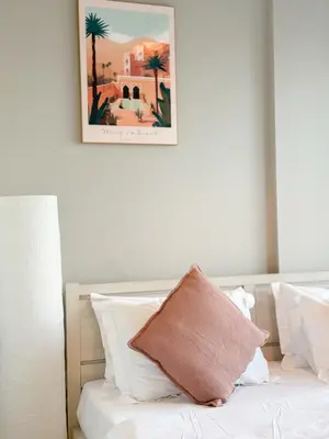 a bedroom with a bed with a picture on the wall at CasaHue - Canal x Burj View - 4Guest - Award Winning in Dubai